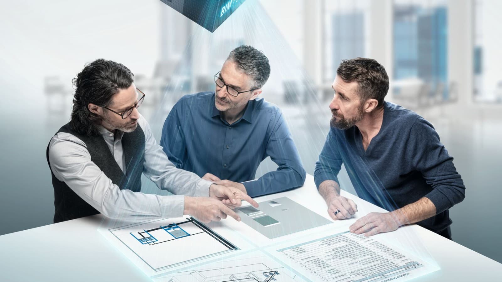 Planeerijad arutlevad BIM-sümboliga laua taga Planeerijad arutlevad BIM-sümboliga laua taga